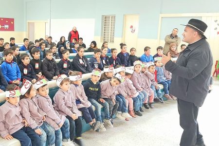 father andre addressing students at school